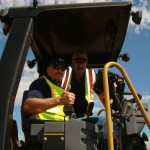 Two workers on equipment during an intelligent compaction demo project in North Dakota
